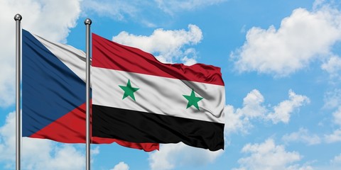 Czech Republic and Syria flag waving in the wind against white cloudy blue sky together. Diplomacy concept, international relations.