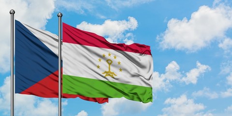Czech Republic and Tajikistan flag waving in the wind against white cloudy blue sky together. Diplomacy concept, international relations.