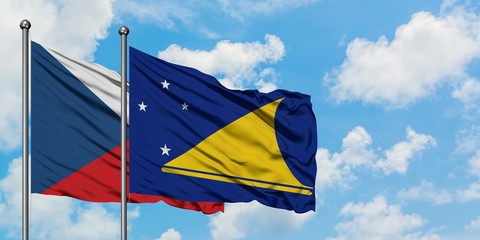Czech Republic and Tokelau flag waving in the wind against white cloudy blue sky together. Diplomacy concept, international relations.