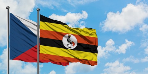 Czech Republic and Uganda flag waving in the wind against white cloudy blue sky together. Diplomacy concept, international relations.