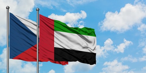 Czech Republic and United Arab Emirates flag waving in the wind against white cloudy blue sky together. Diplomacy concept, international relations.