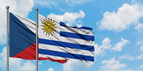 Czech Republic and Uruguay flag waving in the wind against white cloudy blue sky together. Diplomacy concept, international relations.
