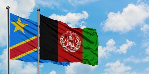 Congo and Afghanistan flag waving in the wind against white cloudy blue sky together. Diplomacy...