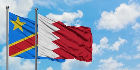 Congo and Bahrain flag waving in the wind against white cloudy blue sky together. Diplomacy concept, international relations.
