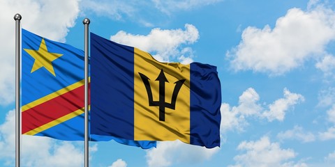 Congo and Barbados flag waving in the wind against white cloudy blue sky together. Diplomacy concept, international relations.
