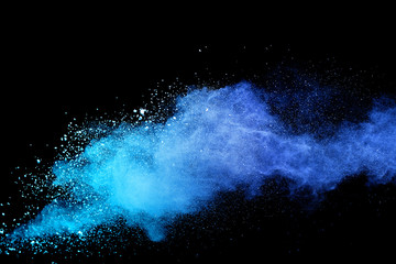 Blue sky color powder explosion on black background.