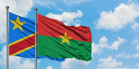 Congo and Burkina Faso flag waving in the wind against white cloudy blue sky together. Diplomacy concept, international relations.