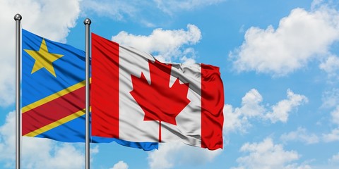 Congo and Canada flag waving in the wind against white cloudy blue sky together. Diplomacy concept, international relations.