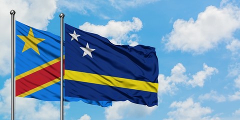 Congo and Curacao flag waving in the wind against white cloudy blue sky together. Diplomacy concept, international relations.