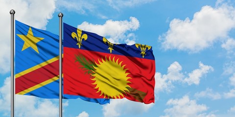 Congo and Guadeloupe flag waving in the wind against white cloudy blue sky together. Diplomacy concept, international relations.