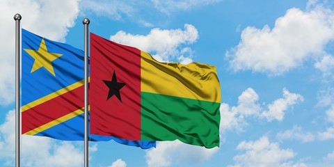 Congo and Guinea Bissau flag waving in the wind against white cloudy blue sky together. Diplomacy concept, international relations.