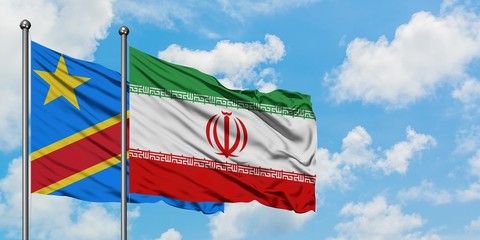 Congo and Iran flag waving in the wind against white cloudy blue sky together. Diplomacy concept, international relations.