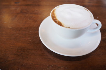 Close up white coffee cup  on table wood.