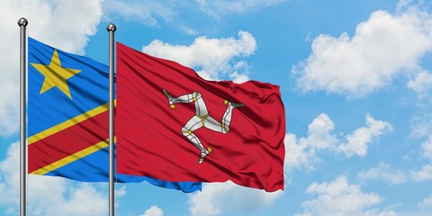 Congo and Isle Of Man flag waving in the wind against white cloudy blue sky together. Diplomacy concept, international relations.