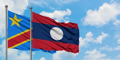 Congo and Laos flag waving in the wind against white cloudy blue sky together. Diplomacy concept, international relations.