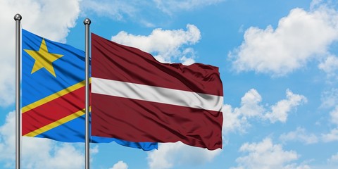 Congo and Latvia flag waving in the wind against white cloudy blue sky together. Diplomacy concept, international relations.