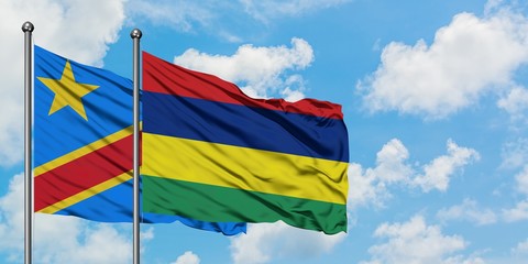 Congo and Mauritius flag waving in the wind against white cloudy blue sky together. Diplomacy concept, international relations.