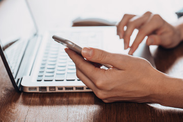 Woman working at home office hand on keyboard close up