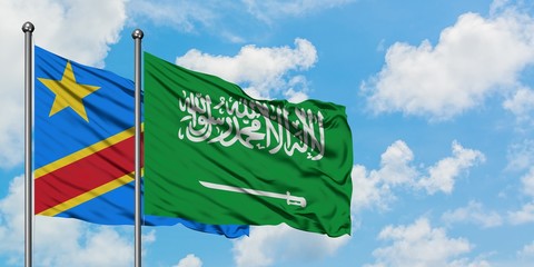 Congo and Saudi Arabia flag waving in the wind against white cloudy blue sky together. Diplomacy concept, international relations.