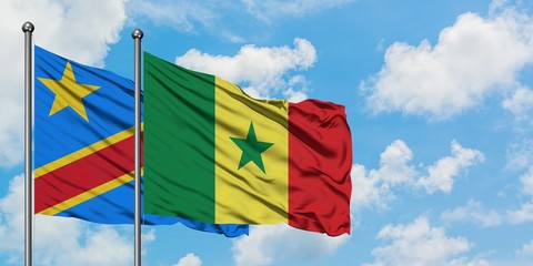 Congo and Senegal flag waving in the wind against white cloudy blue sky together. Diplomacy concept, international relations.
