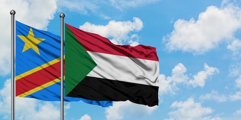 Congo and Sudan flag waving in the wind against white cloudy blue sky together. Diplomacy concept, international relations.