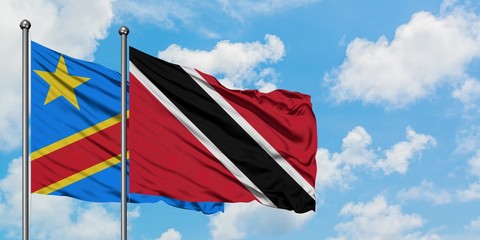 Congo and Trinidad And Tobago flag waving in the wind against white cloudy blue sky together. Diplomacy concept, international relations.