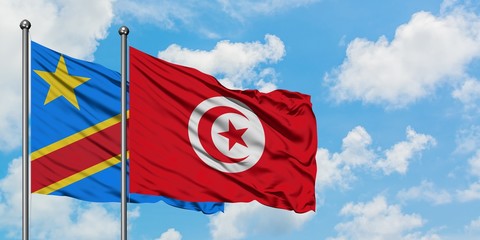 Congo and Tunisia flag waving in the wind against white cloudy blue sky together. Diplomacy concept, international relations.