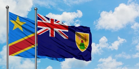 Congo and Turks And Caicos Islands flag waving in the wind against white cloudy blue sky together. Diplomacy concept, international relations.