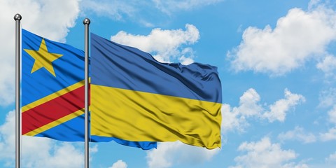 Congo and Ukraine flag waving in the wind against white cloudy blue sky together. Diplomacy concept, international relations.