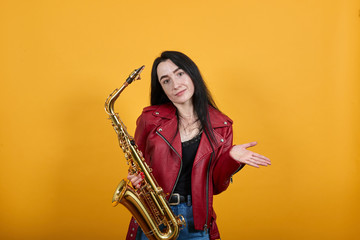 Arrogant haughty young woman in nice red jacket spreading, pointing hands aside isolated on yellow orange wall background in studio. People sincere emotions, lifestyle concept.