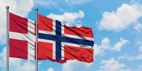 Denmark and Bouvet Islands flag waving in the wind against white cloudy blue sky together. Diplomacy concept, international relations.