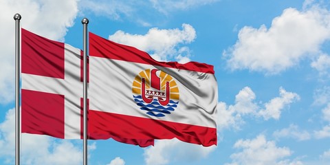 Denmark and French Polynesia flag waving in the wind against white cloudy blue sky together. Diplomacy concept, international relations.