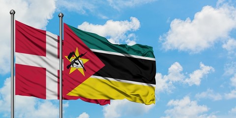 Denmark and Mozambique flag waving in the wind against white cloudy blue sky together. Diplomacy concept, international relations.