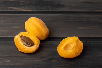 Juicy ripe apricot on a wooden desk