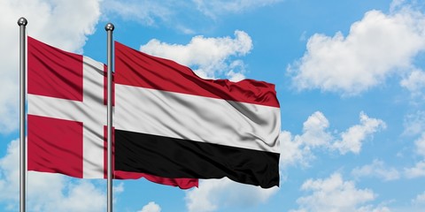 Denmark and Yemen flag waving in the wind against white cloudy blue sky together. Diplomacy concept, international relations.