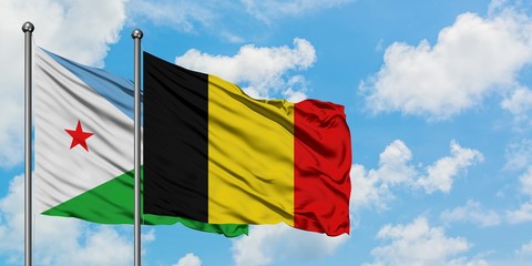 Djibouti and Belgium flag waving in the wind against white cloudy blue sky together. Diplomacy concept, international relations.