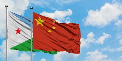 Djibouti and China flag waving in the wind against white cloudy blue sky together. Diplomacy concept, international relations.