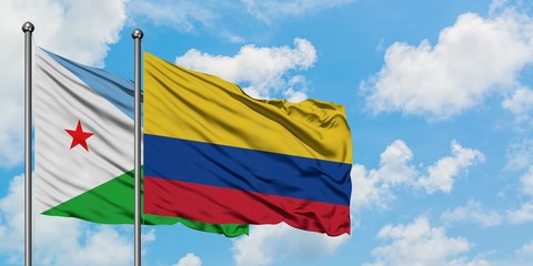Djibouti and Colombia flag waving in the wind against white cloudy blue sky together. Diplomacy concept, international relations.