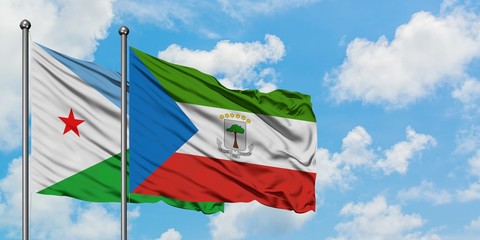 Djibouti and Equatorial Guinea flag waving in the wind against white cloudy blue sky together. Diplomacy concept, international relations.