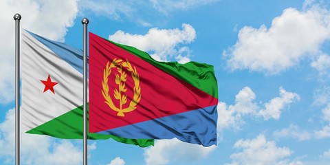 Djibouti and Eritrea flag waving in the wind against white cloudy blue sky together. Diplomacy concept, international relations.