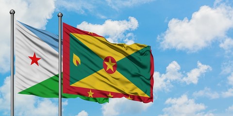 Djibouti and Grenada flag waving in the wind against white cloudy blue sky together. Diplomacy concept, international relations.