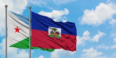 Djibouti and Haiti flag waving in the wind against white cloudy blue sky together. Diplomacy concept, international relations.