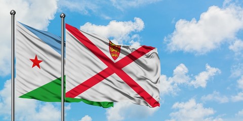 Djibouti and Jersey flag waving in the wind against white cloudy blue sky together. Diplomacy...