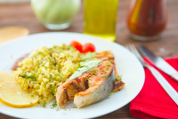 Rise noodles with salmon and vegetable on wooden table