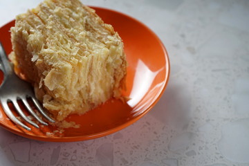A piece of puff cake on a bright plate