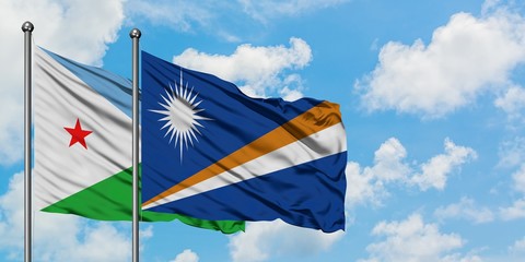 Djibouti and Marshall Islands flag waving in the wind against white cloudy blue sky together. Diplomacy concept, international relations.