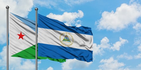Djibouti and Nicaragua flag waving in the wind against white cloudy blue sky together. Diplomacy concept, international relations.