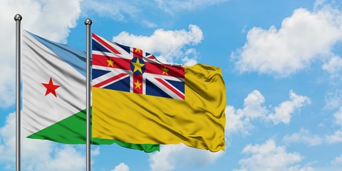 Djibouti and Niue flag waving in the wind against white cloudy blue sky together. Diplomacy concept, international relations.