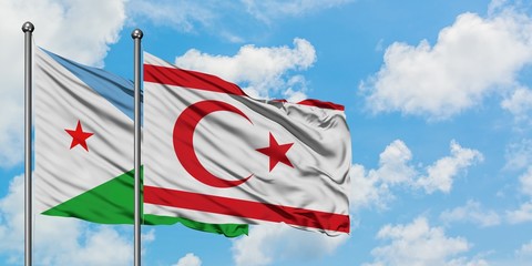 Djibouti and Northern Cyprus flag waving in the wind against white cloudy blue sky together. Diplomacy concept, international relations.