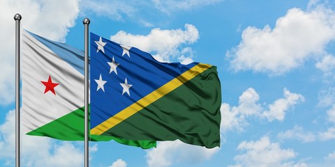 Djibouti and Solomon Islands flag waving in the wind against white cloudy blue sky together. Diplomacy concept, international relations.